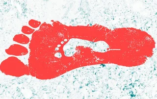 Devolution - a red footprint against a snowy background