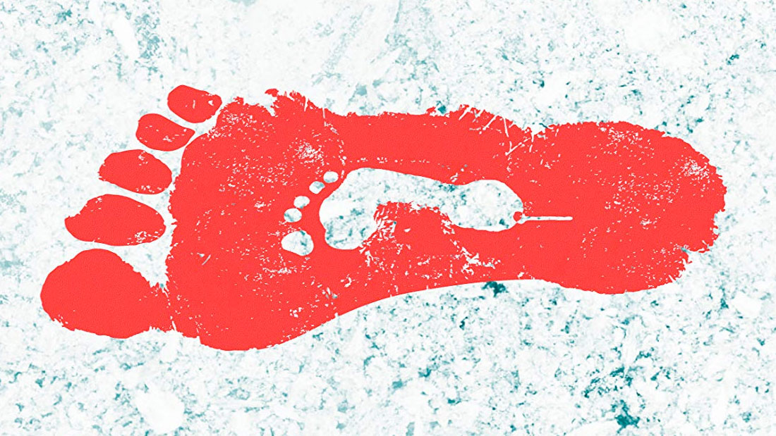 Devolution - a red footprint against a snowy background